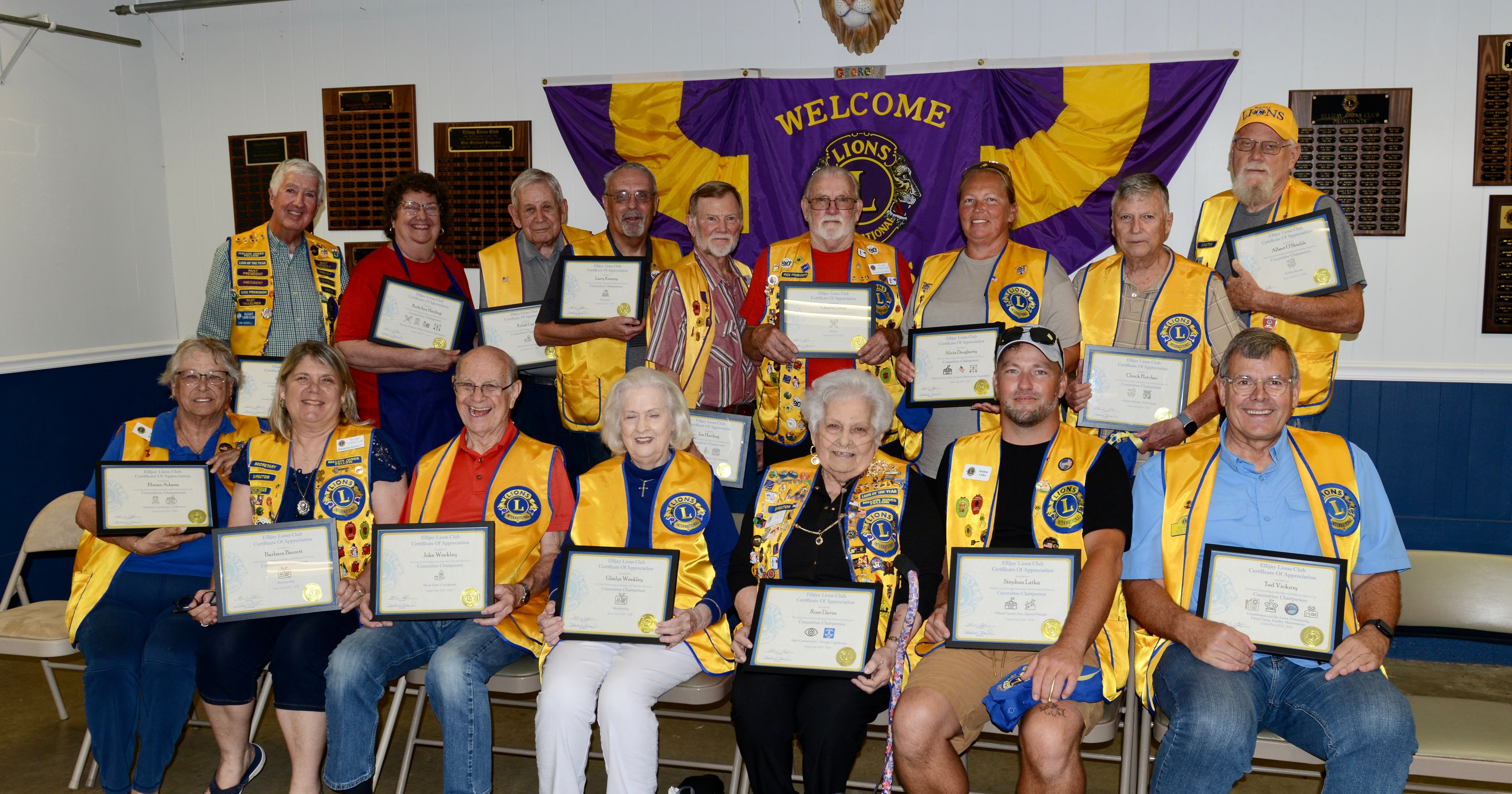 Lions Club members holding award certificates at the ceremony