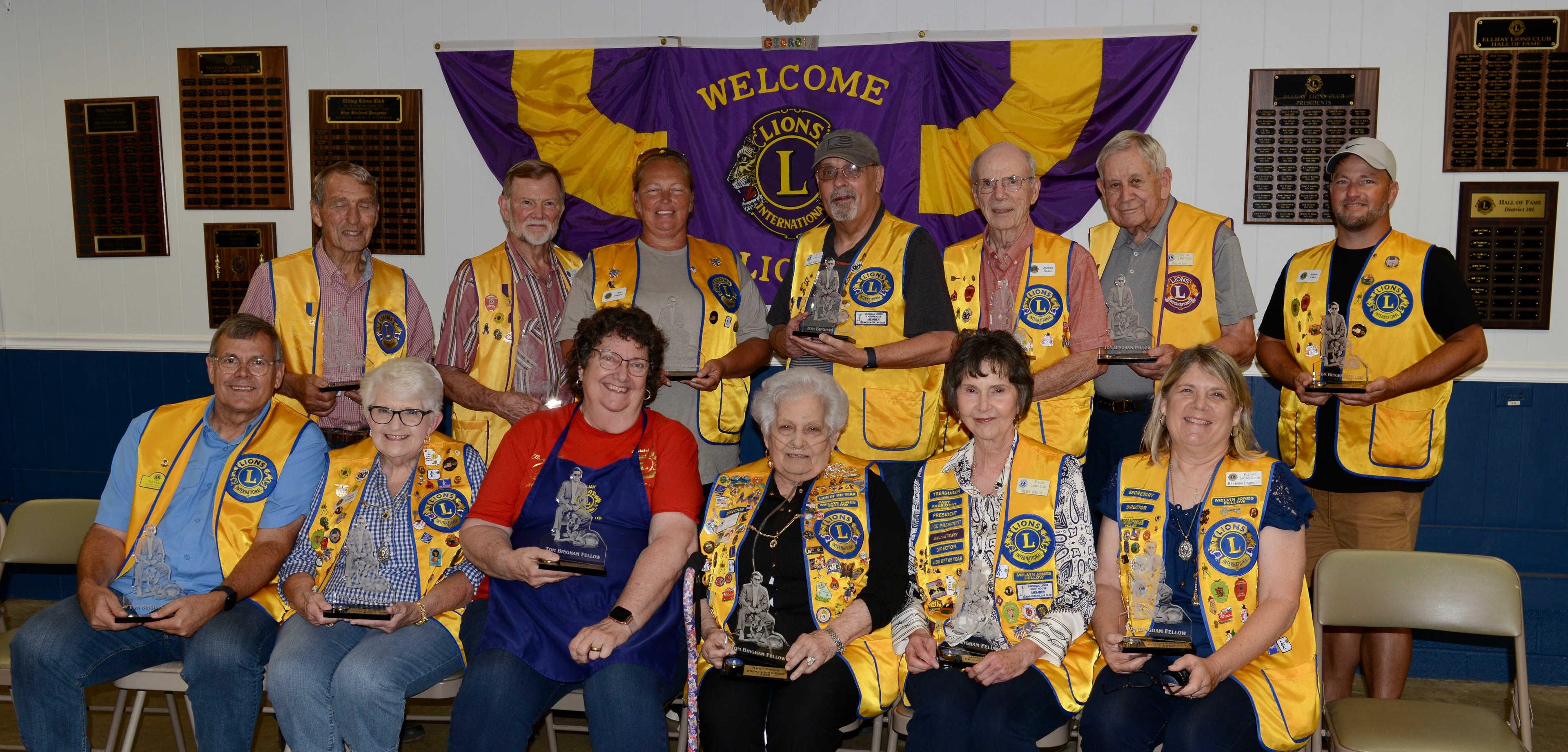 Lions Club members posing together indoors at the ceremony
