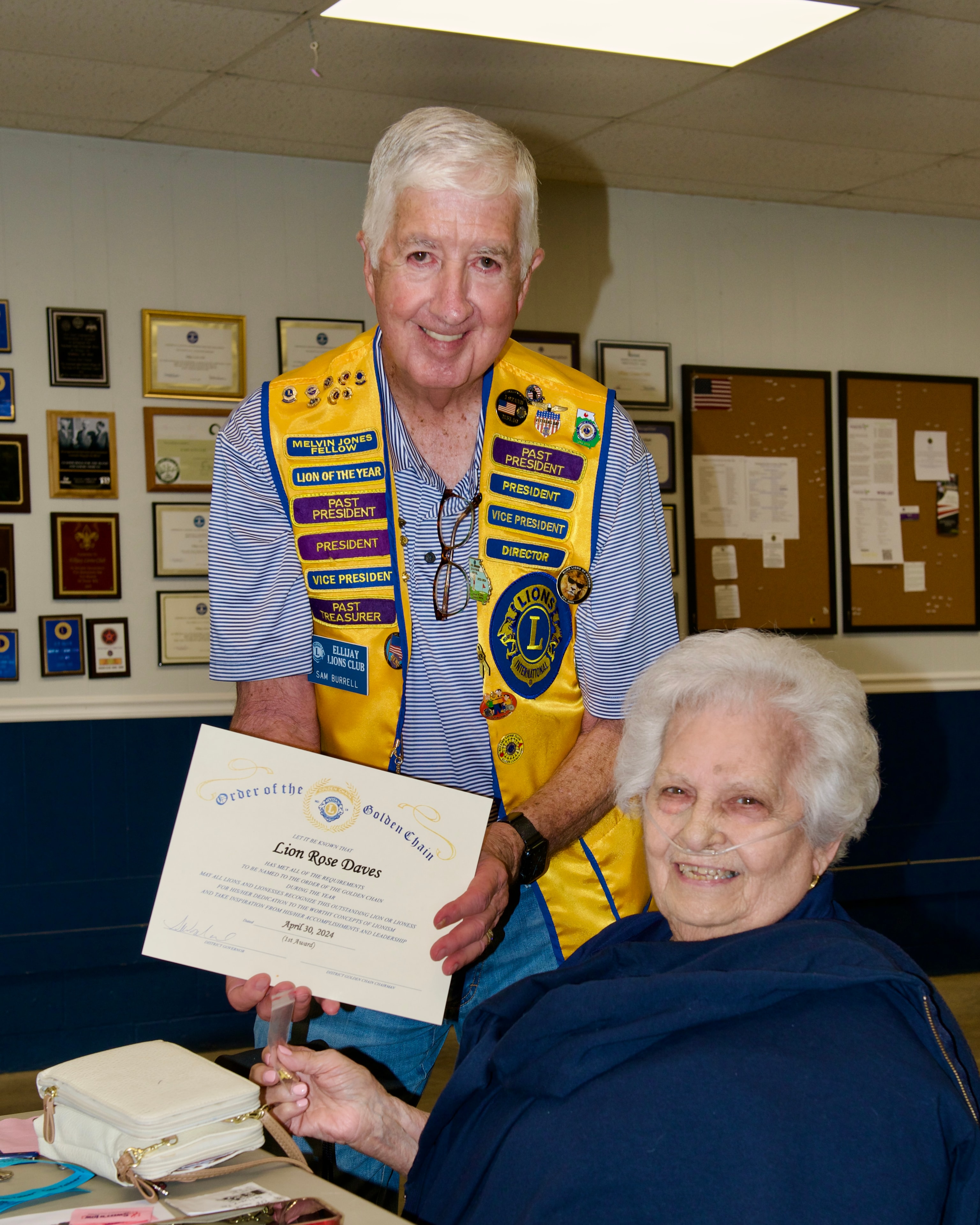 Senior Lions Club member presenting an award certificate at the ceremony