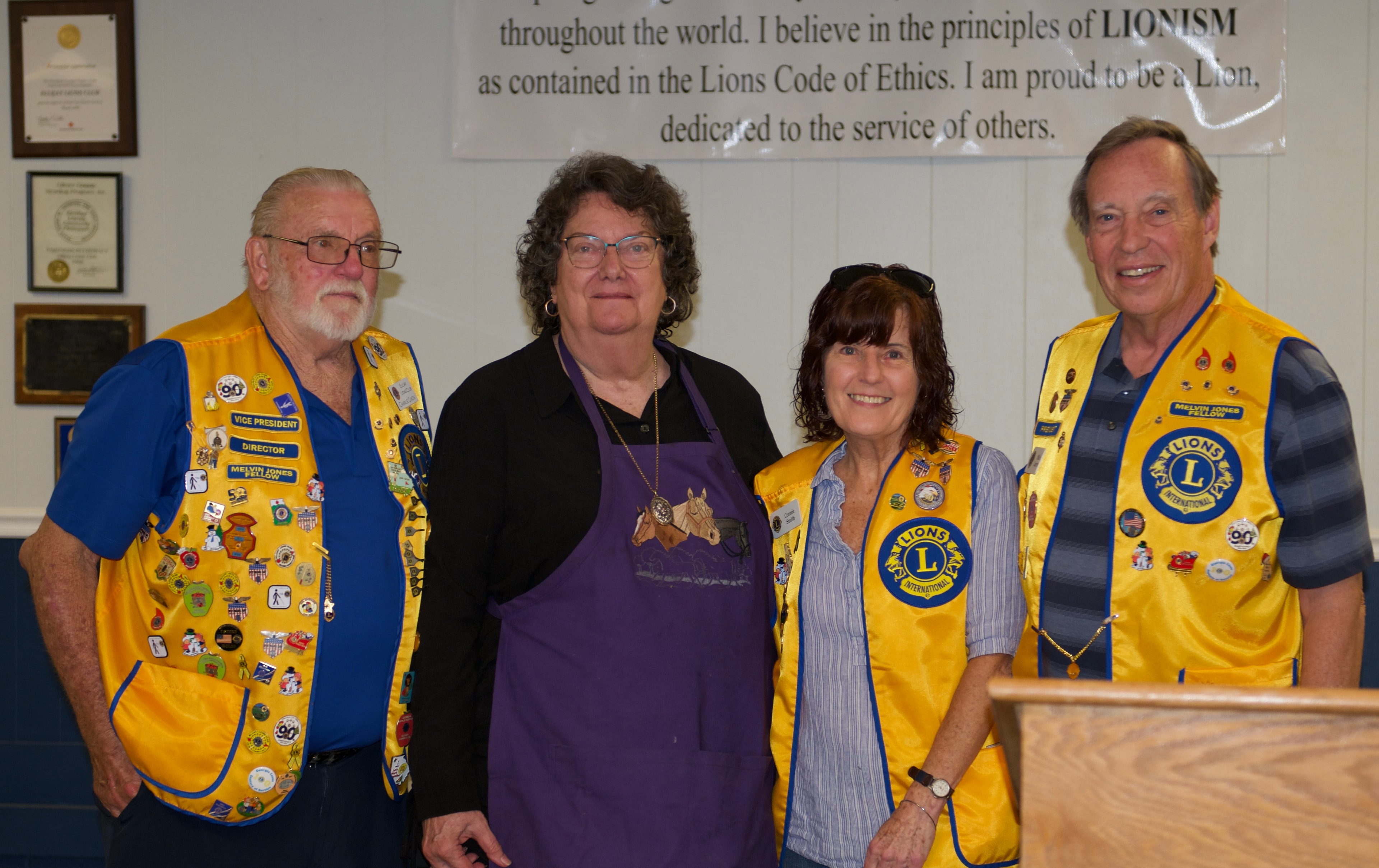 Lions Club members posing together indoors at the ceremony