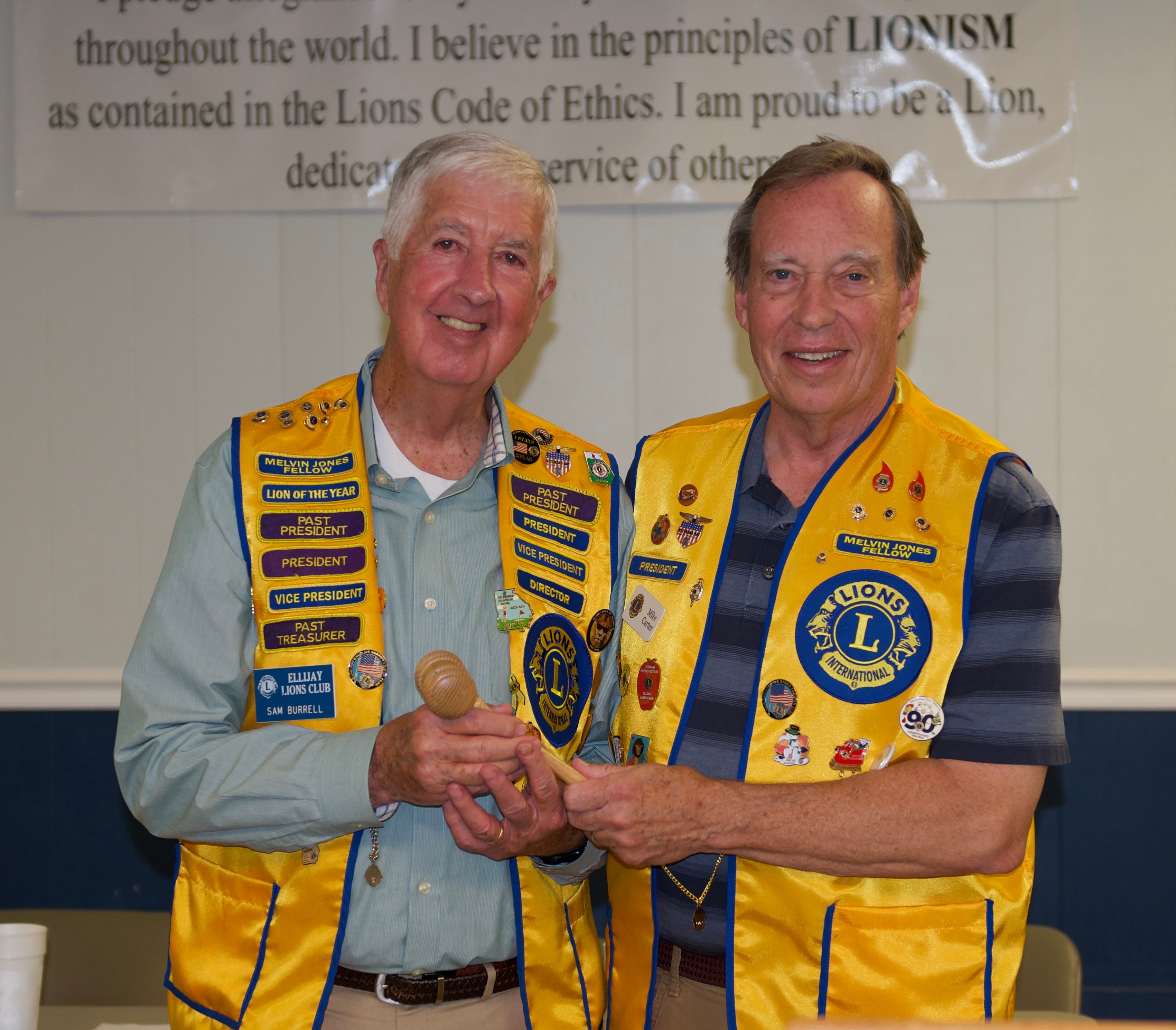 Two Lions Club members shaking hands at the ceremony