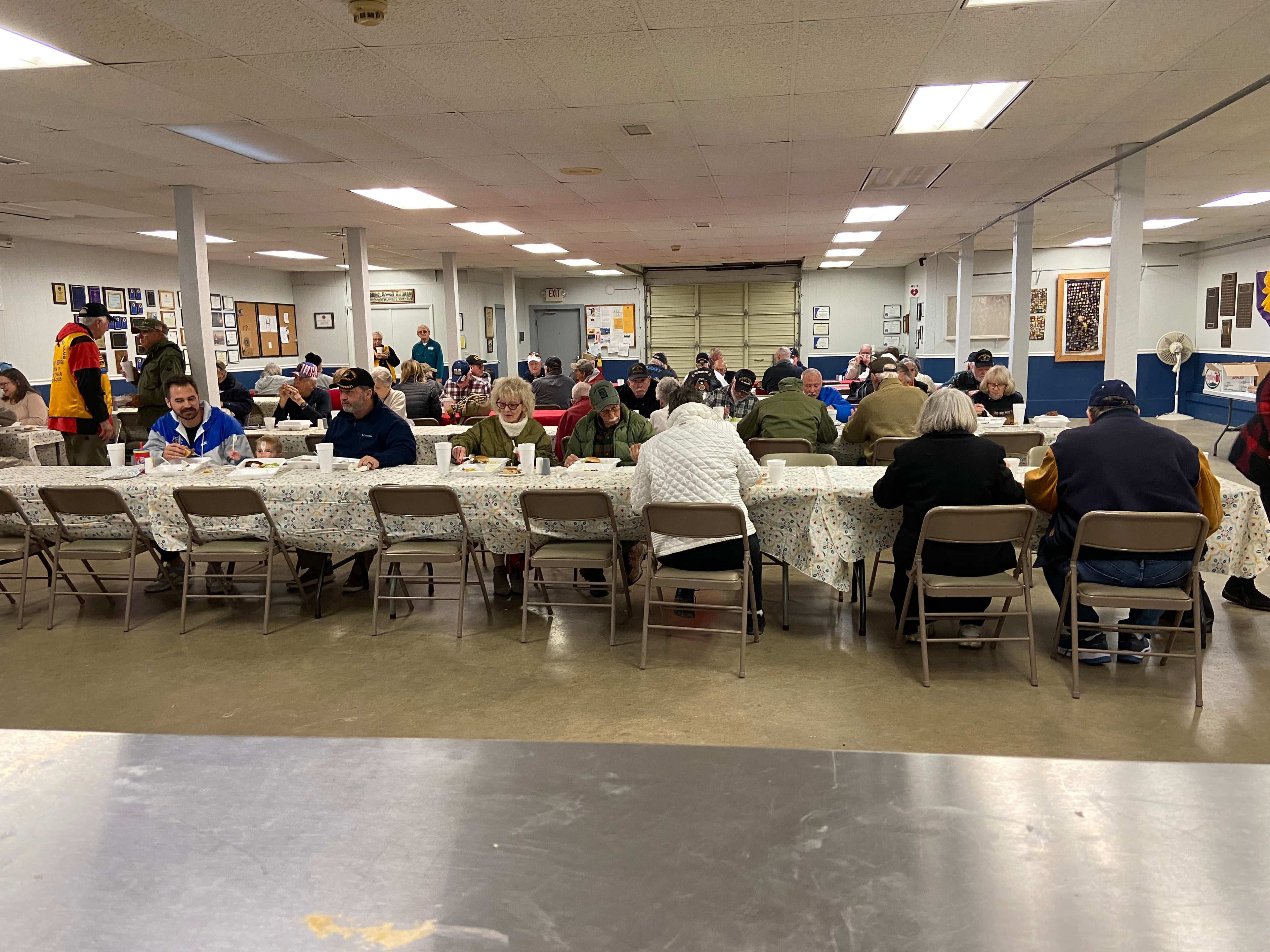 Full meeting room of Lions Club members seated at tables