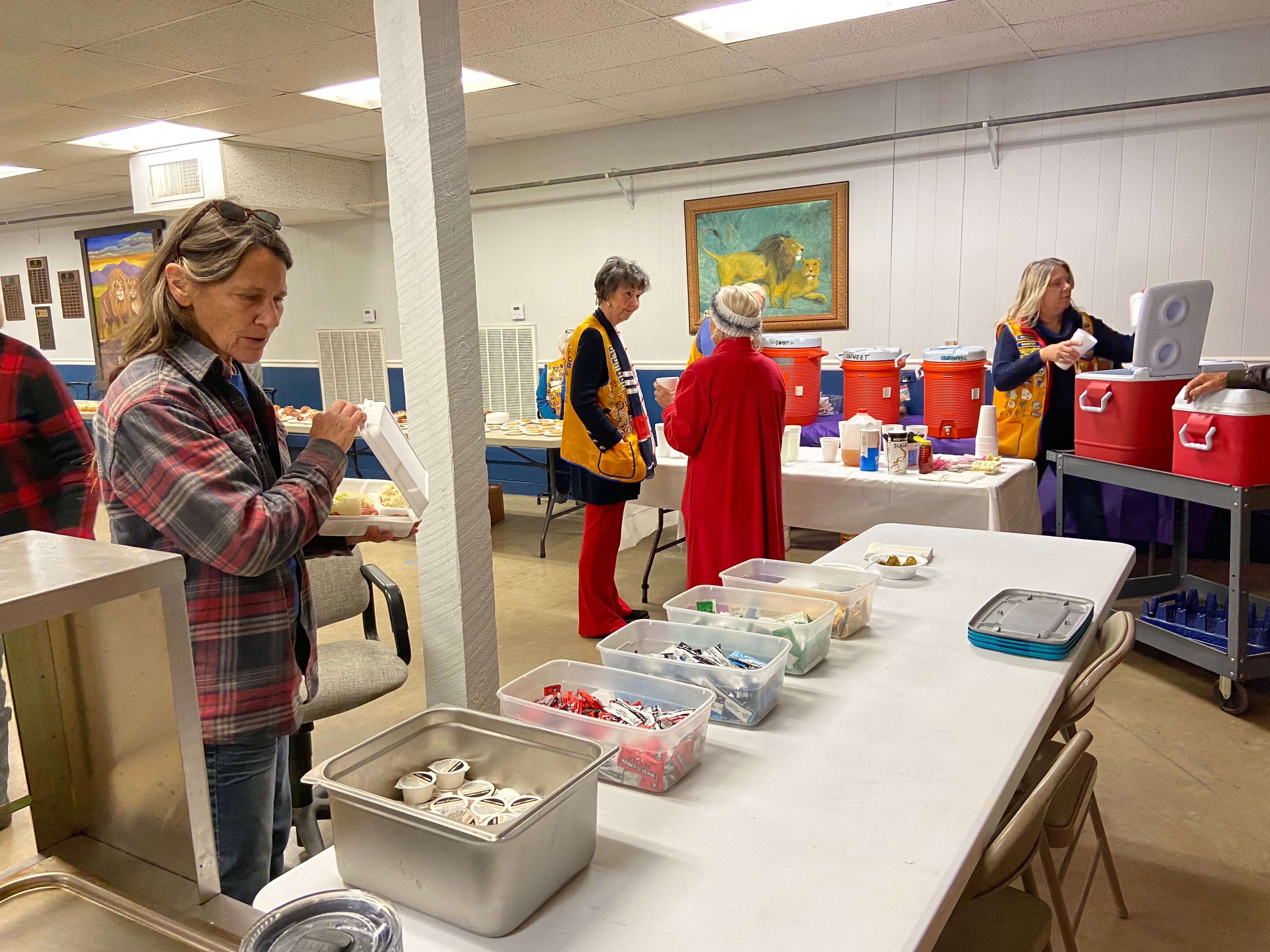 Lions Club members serving food and refreshments at a monthly meeting