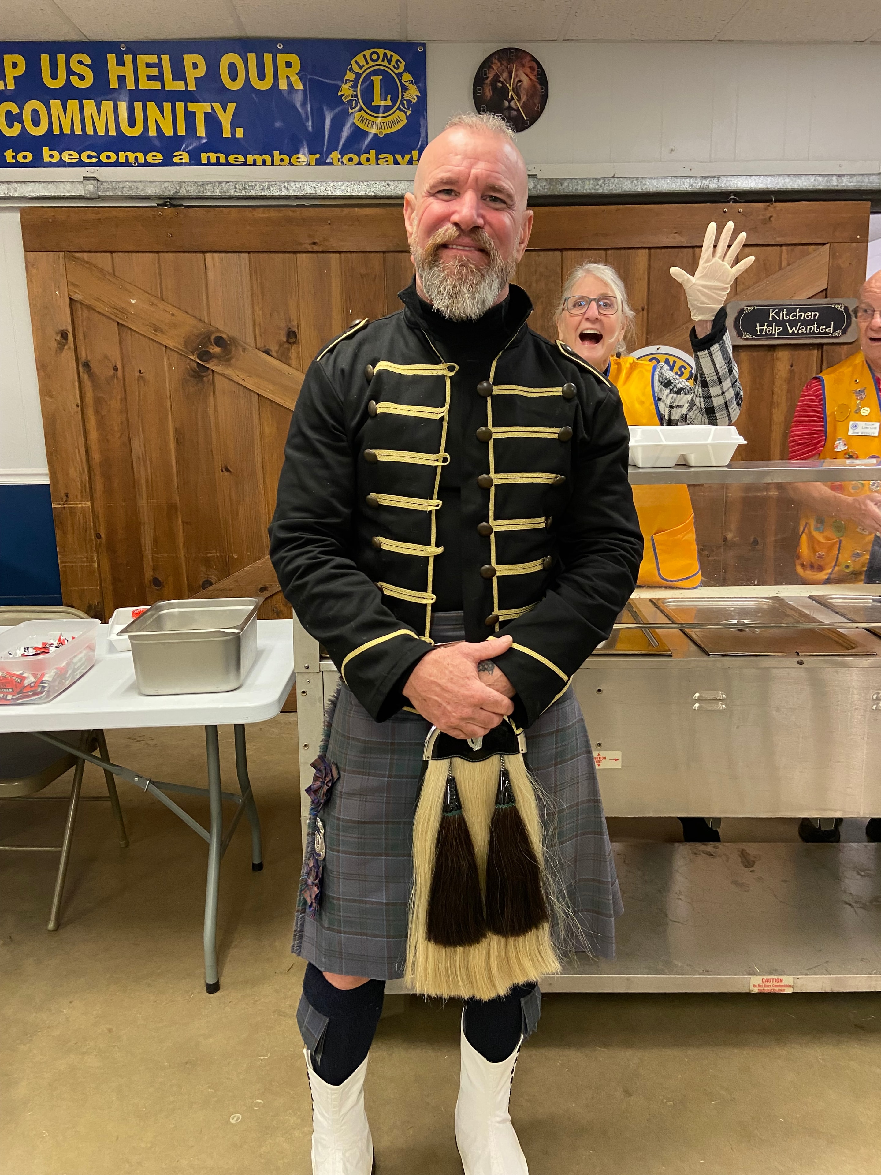 Guest speaker in Scottish kilt and military jacket at a Lions Club meeting