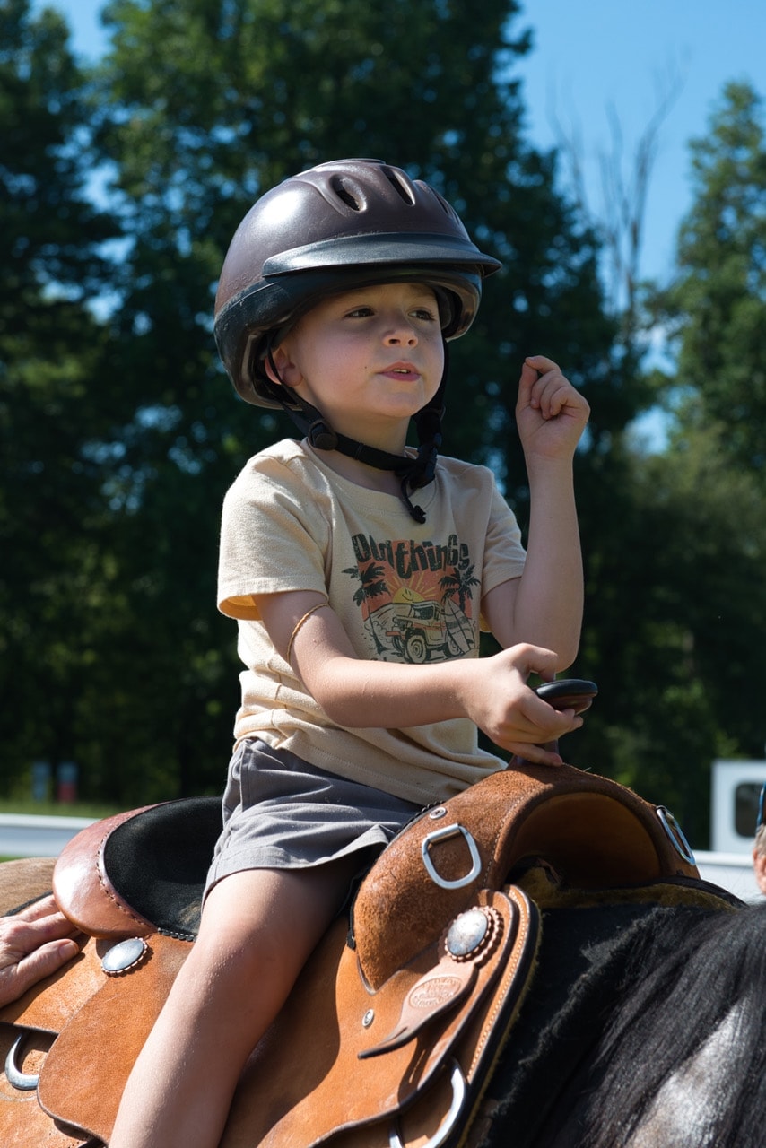 Child riding horse at Special Friends event