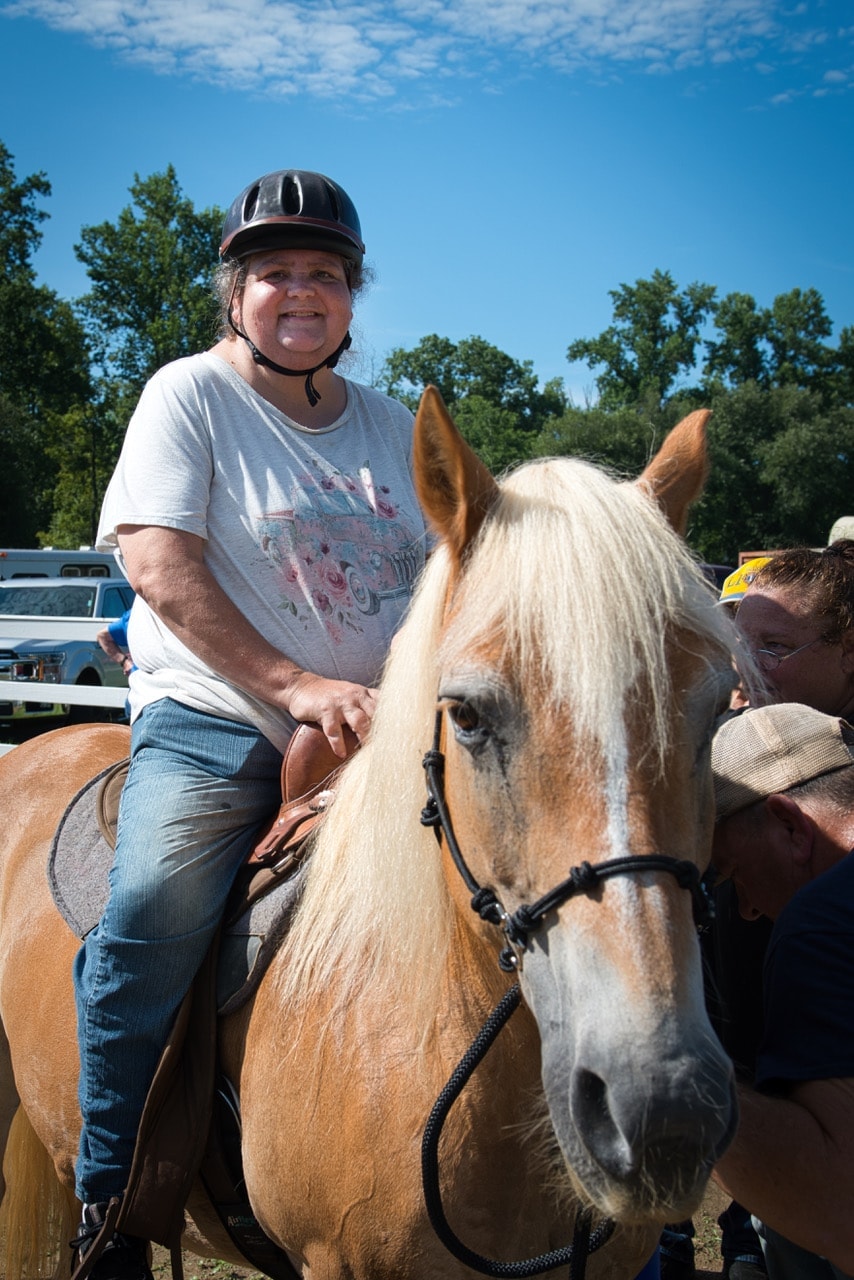 Participant riding palomino horse