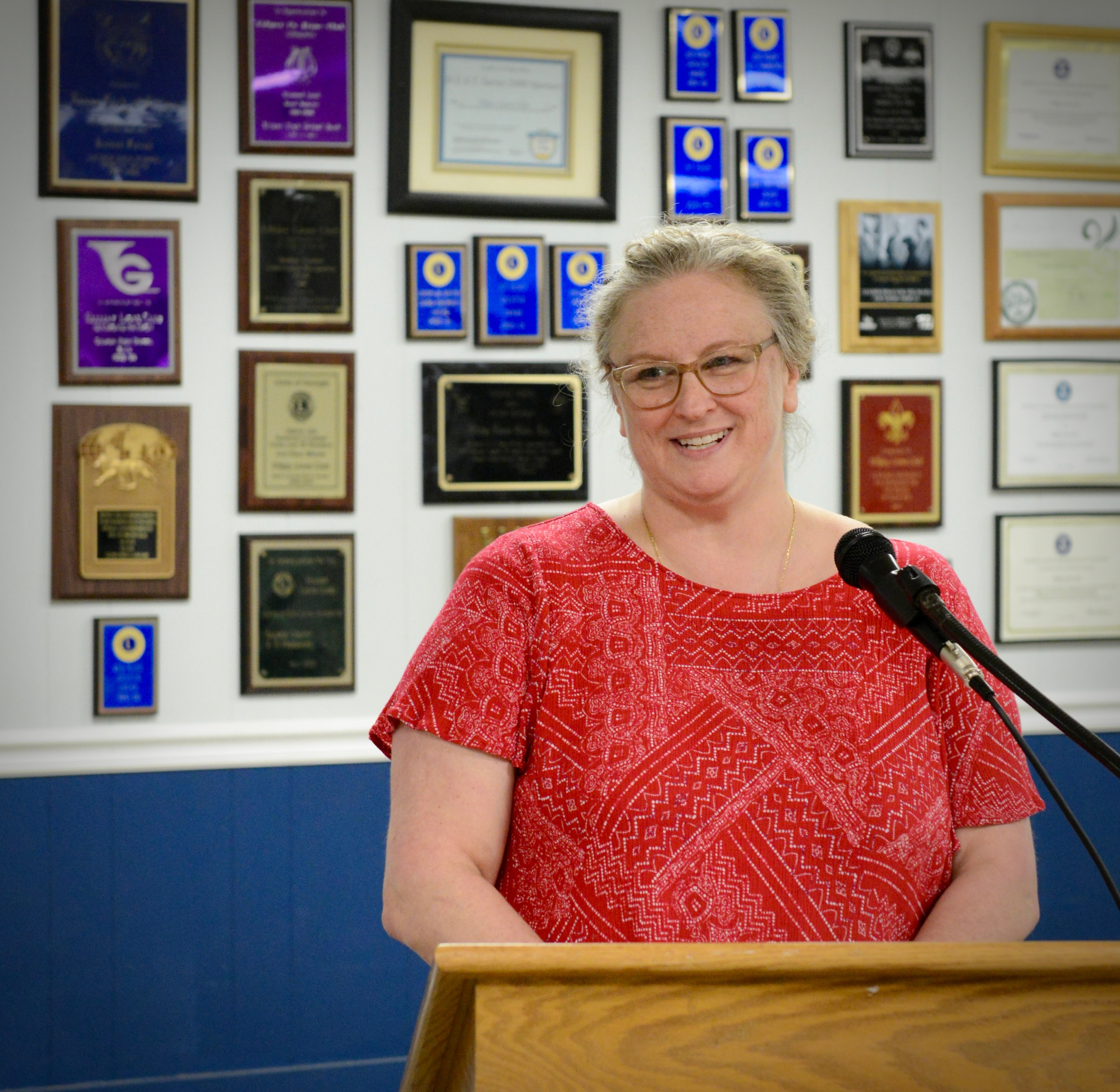 Woman speaking at the podium during a Lions Club monthly meeting