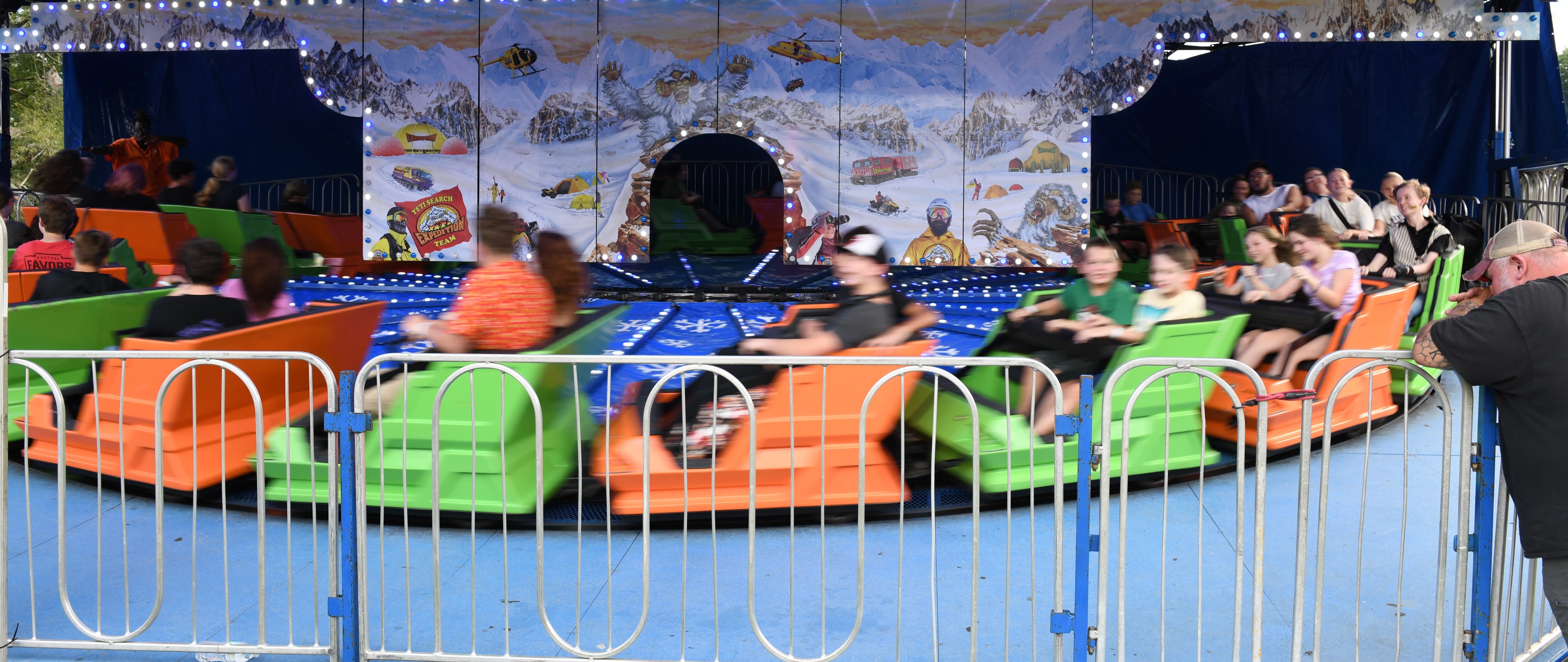 People riding a spinning amusement park ride at the Gilmer County Fair