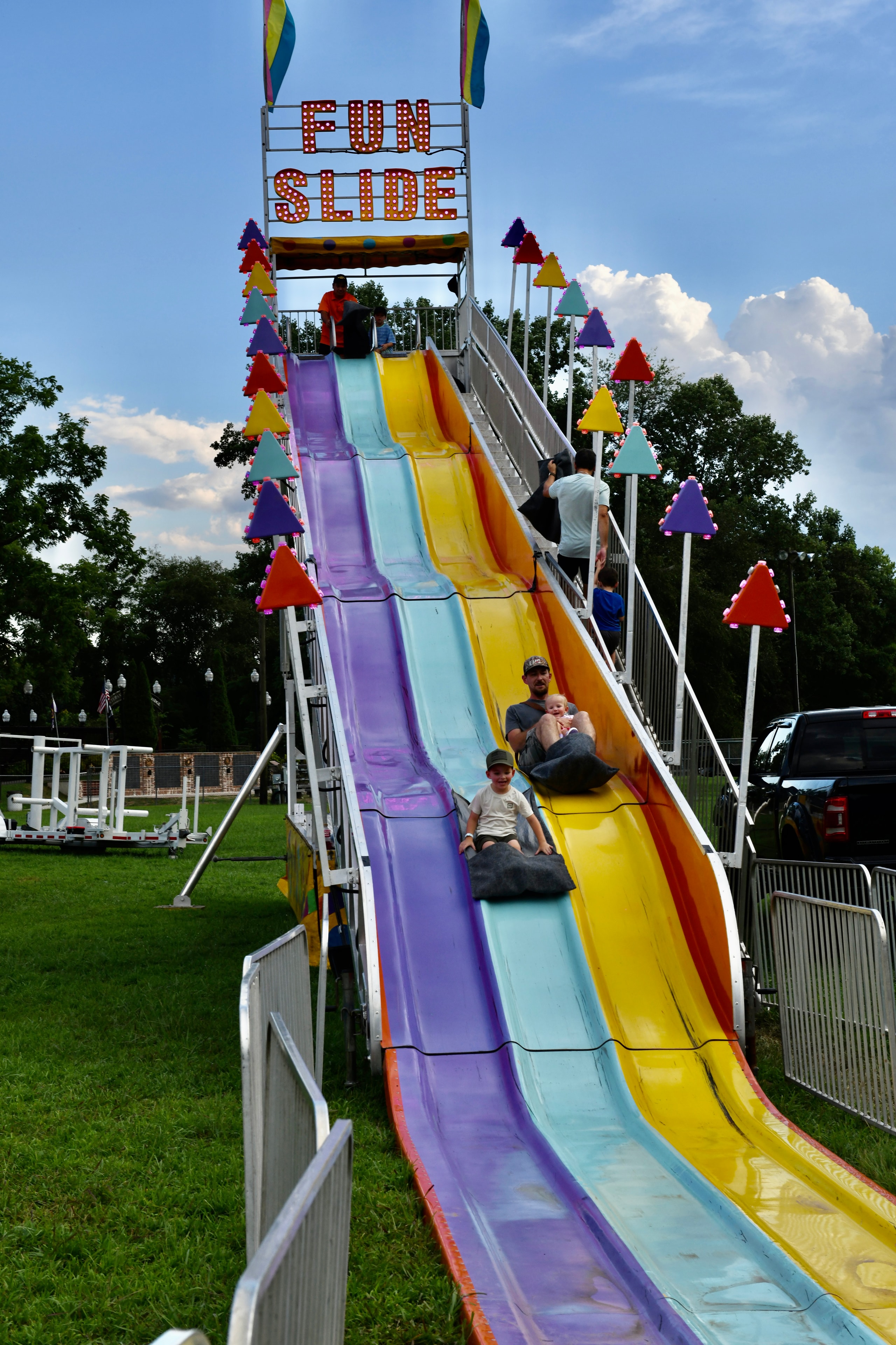 Lions Club member with her three grandsons at the Gilmer County Fair carnival slide