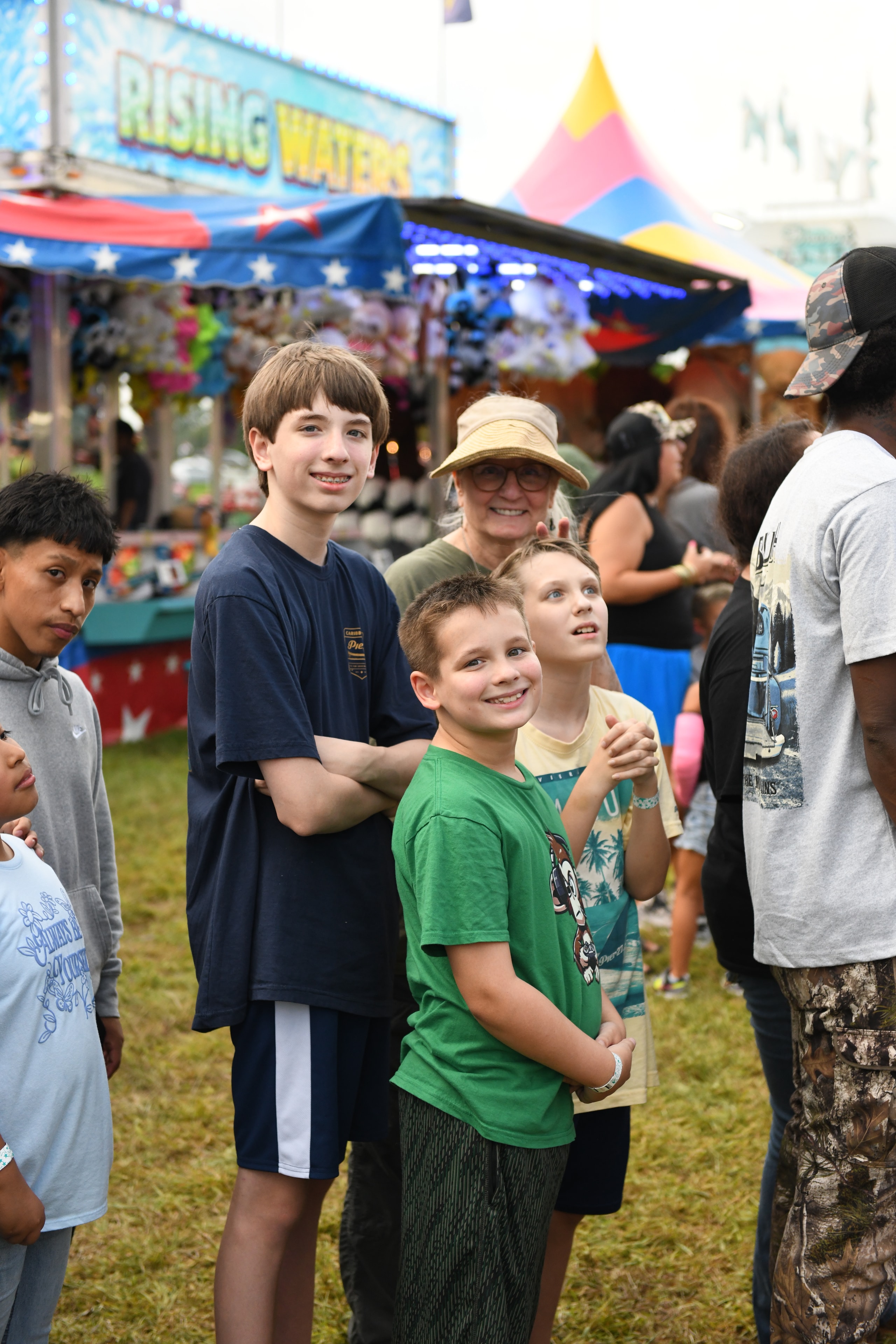 Children gathered at a carnival game booth at the Gilmer County Fair