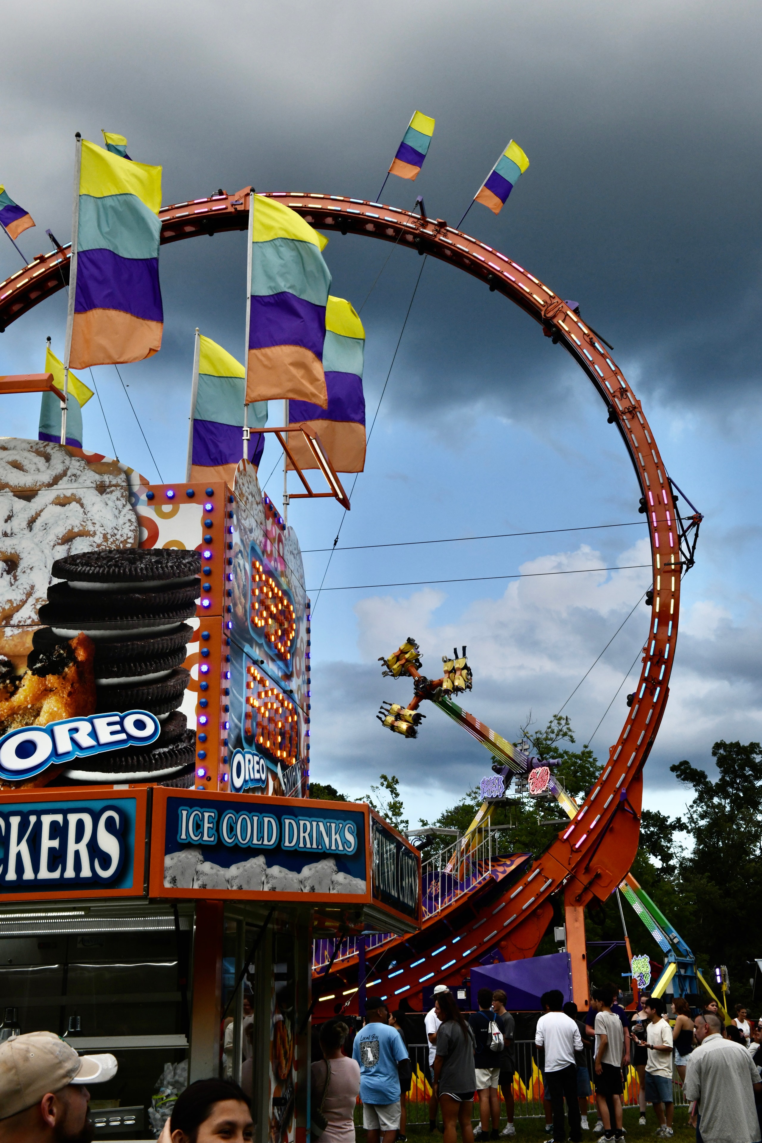 Carnival ride with colorful flags and Oreo stand at the Gilmer County Fair