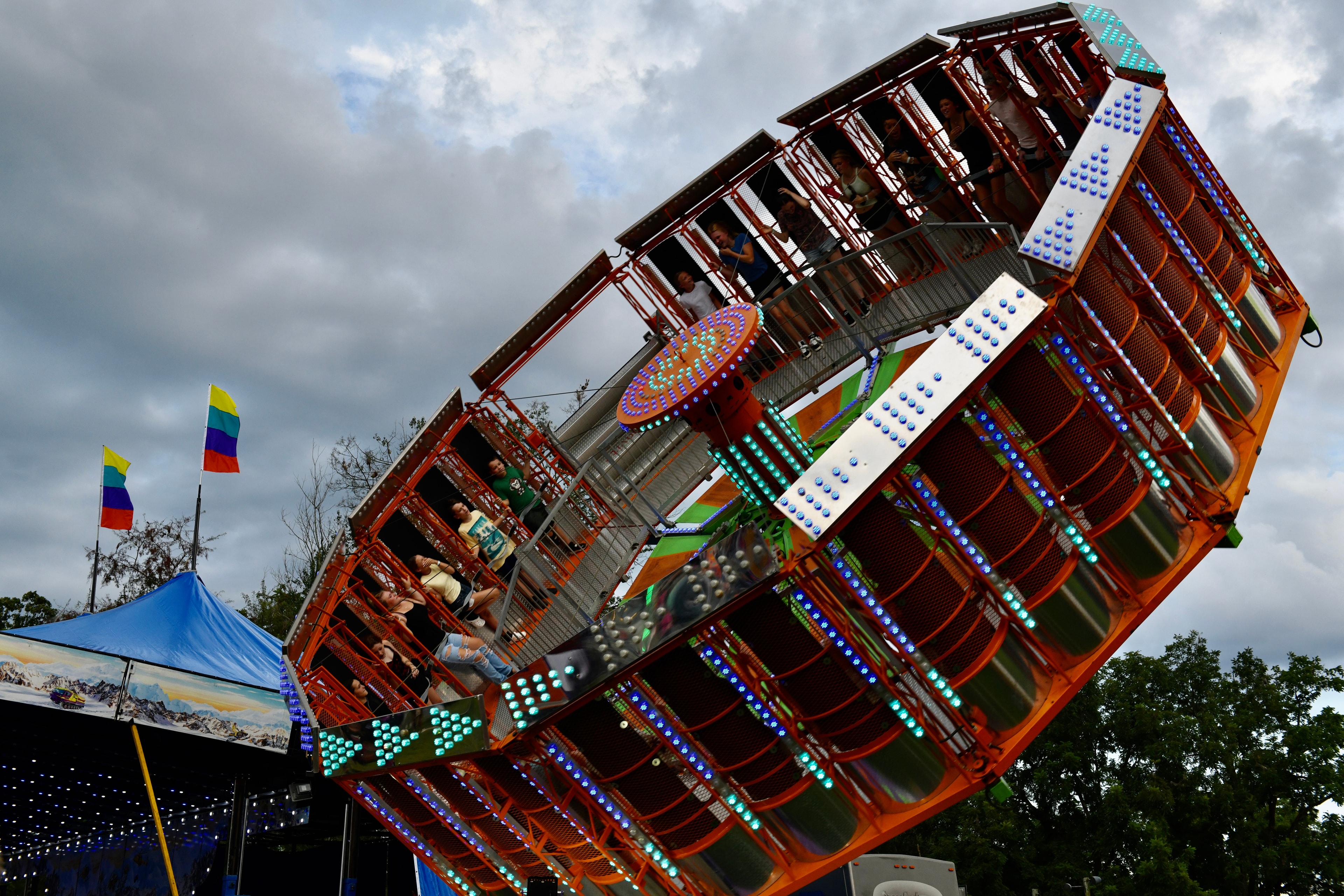 Tilting carnival ride with riders and lights at the Gilmer County Fair