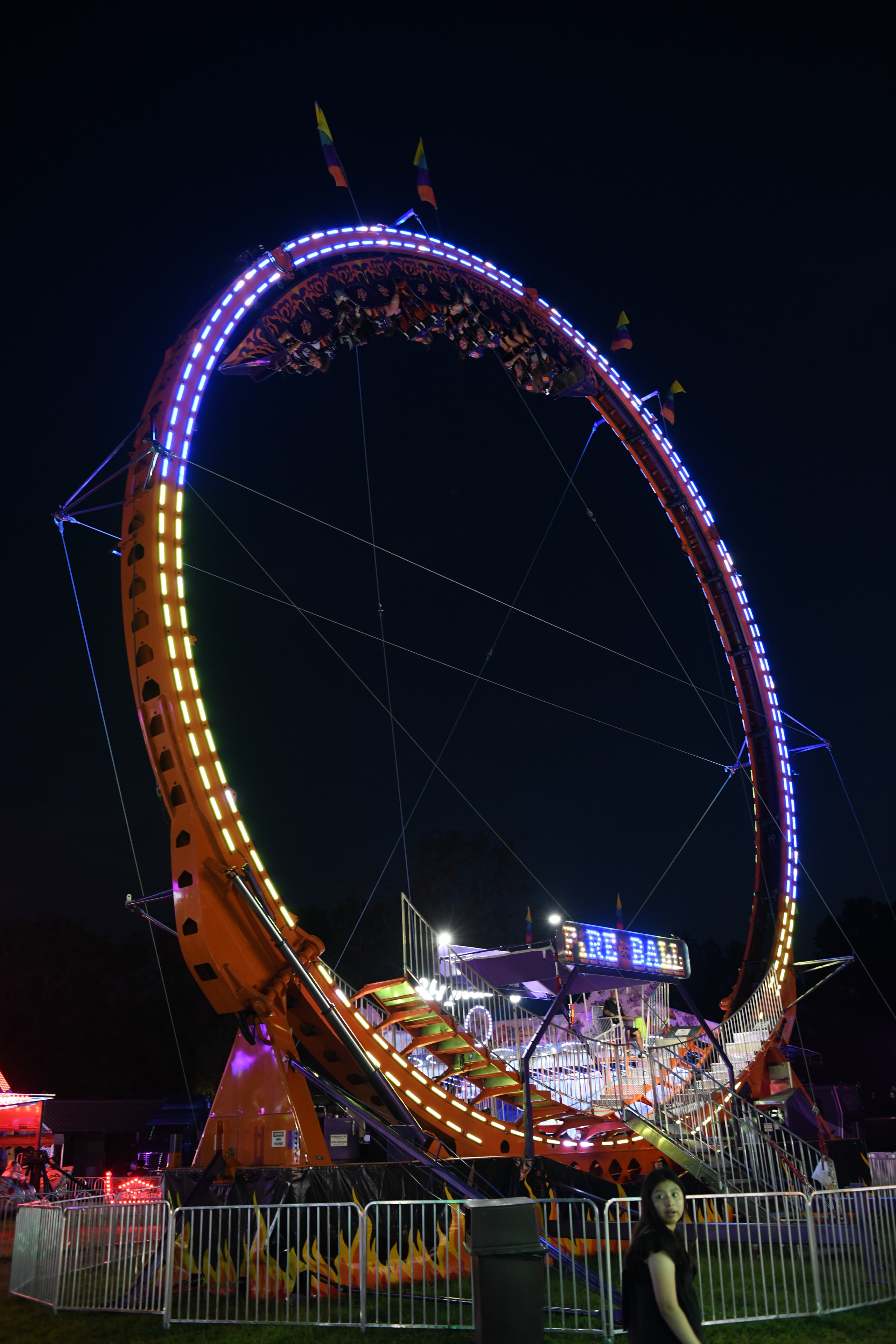 Illuminated carnival pendulum ride at night at the Gilmer County Fair