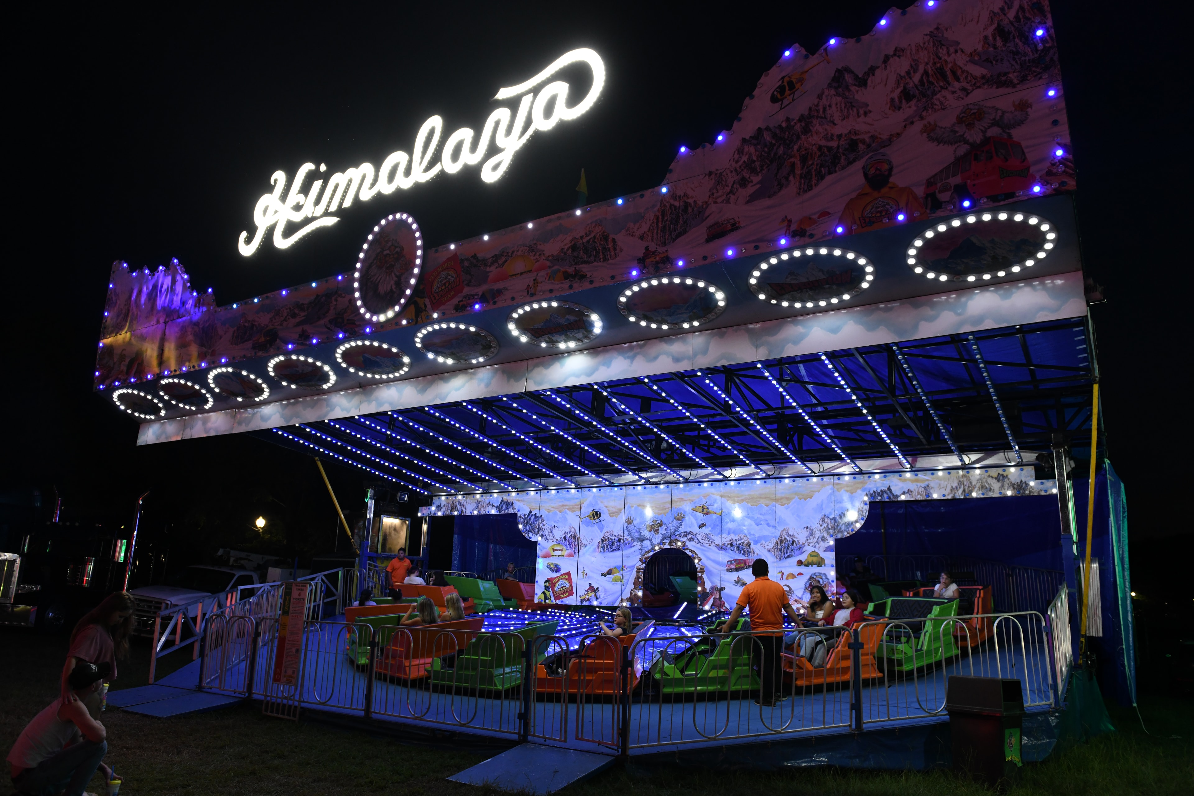 Illuminated Himalaya carnival ride at night at the Gilmer County Fair