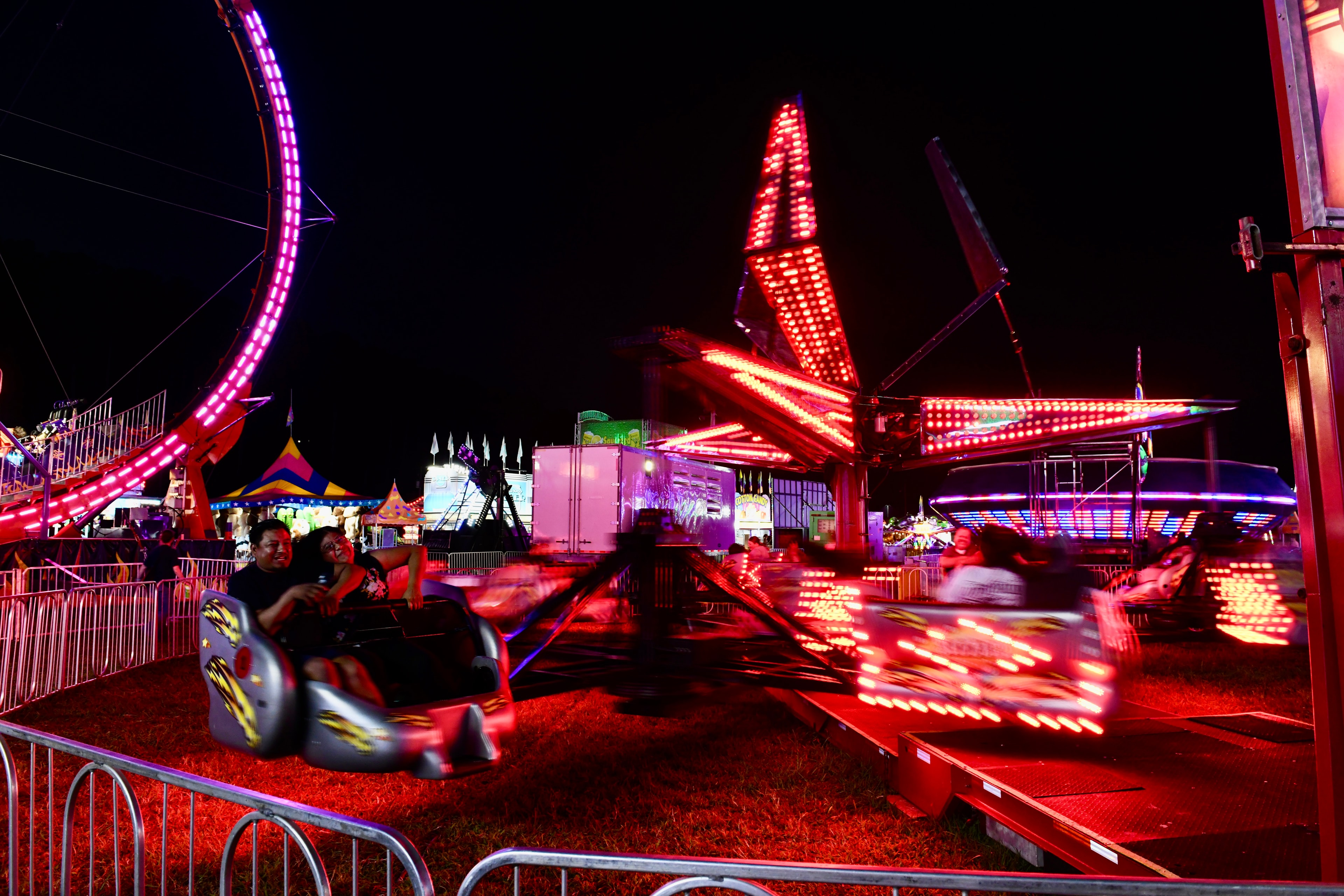 Illuminated carnival ride spinning at night at the Gilmer County Fair