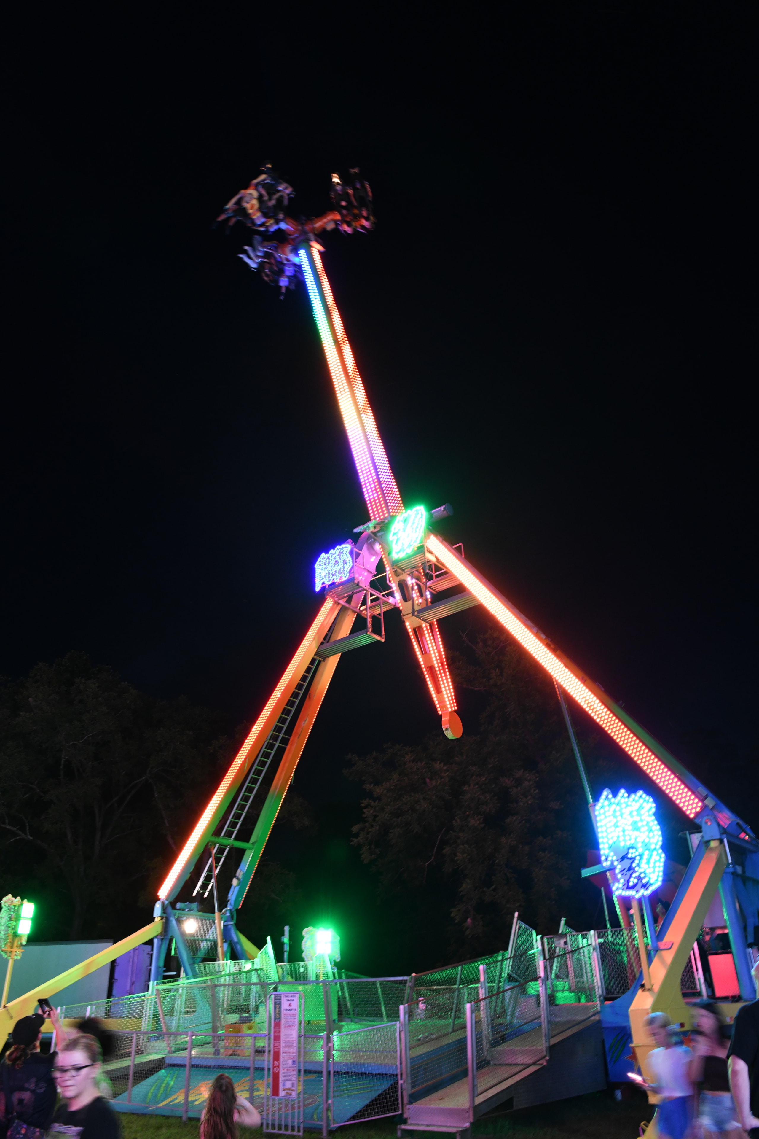 Illuminated amusement park ride at night at the Gilmer County Fair