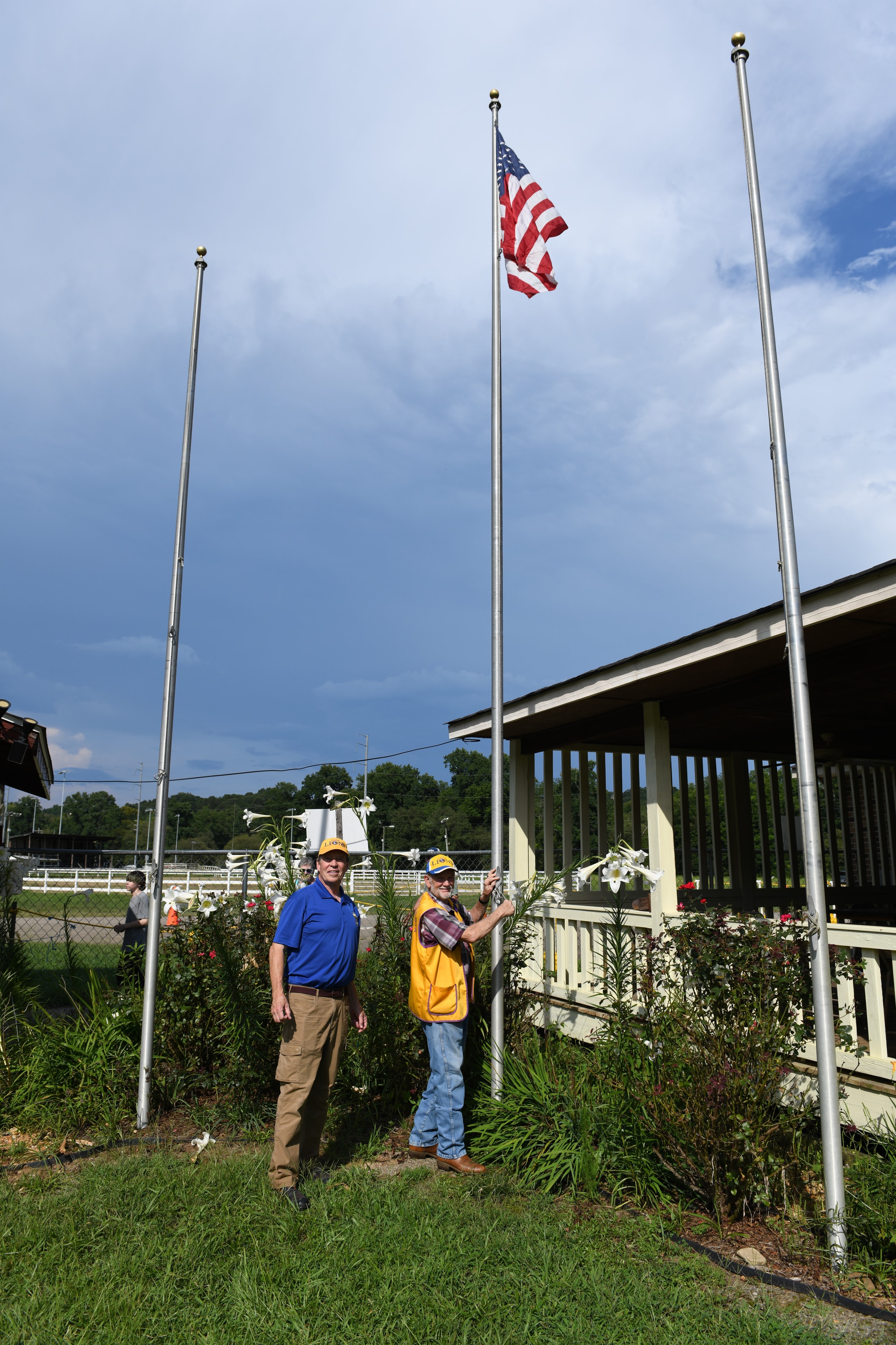 Men raising the American flag at the Gilmer County Fair