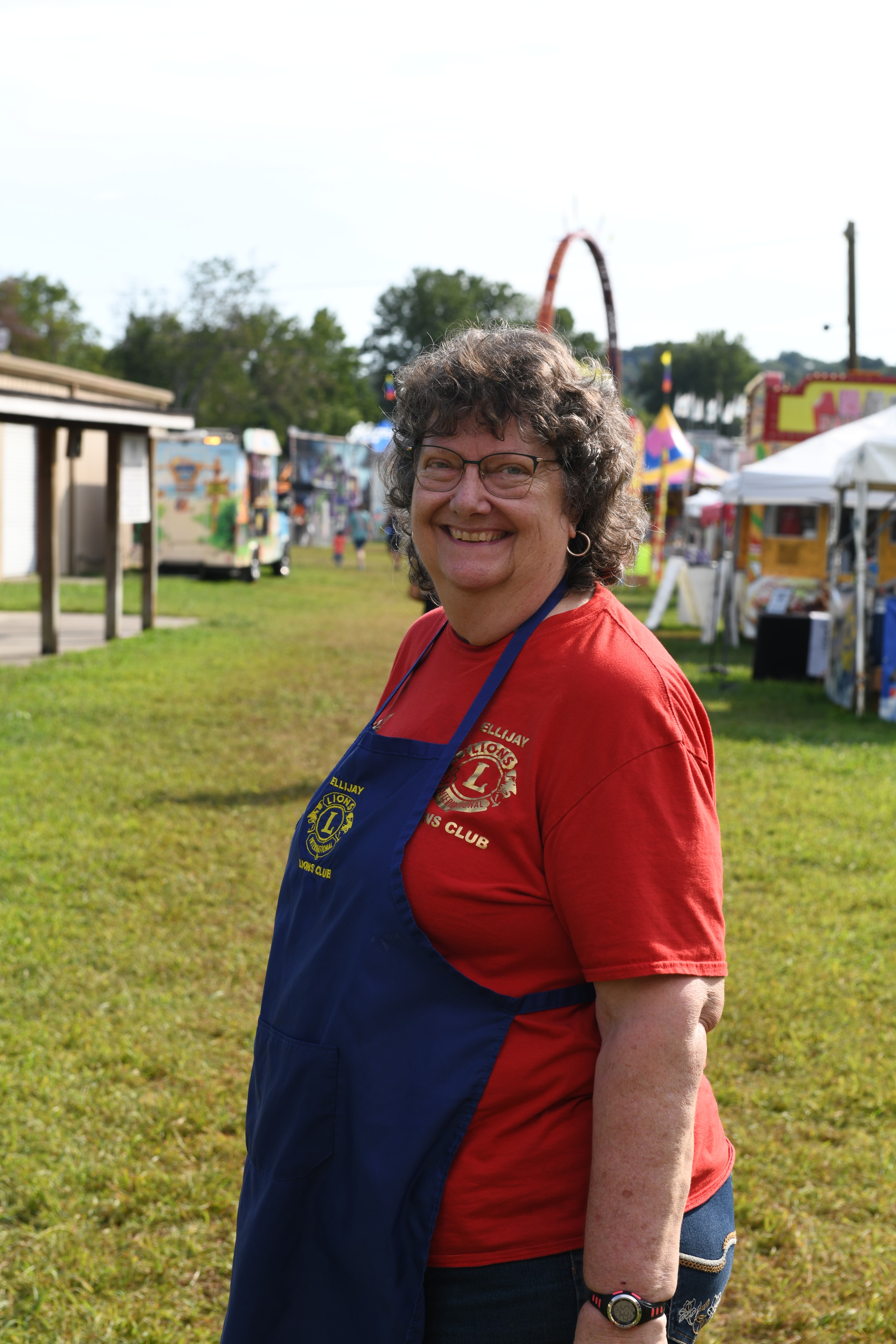 Smiling woman wearing an apron at the Gilmer County Fair