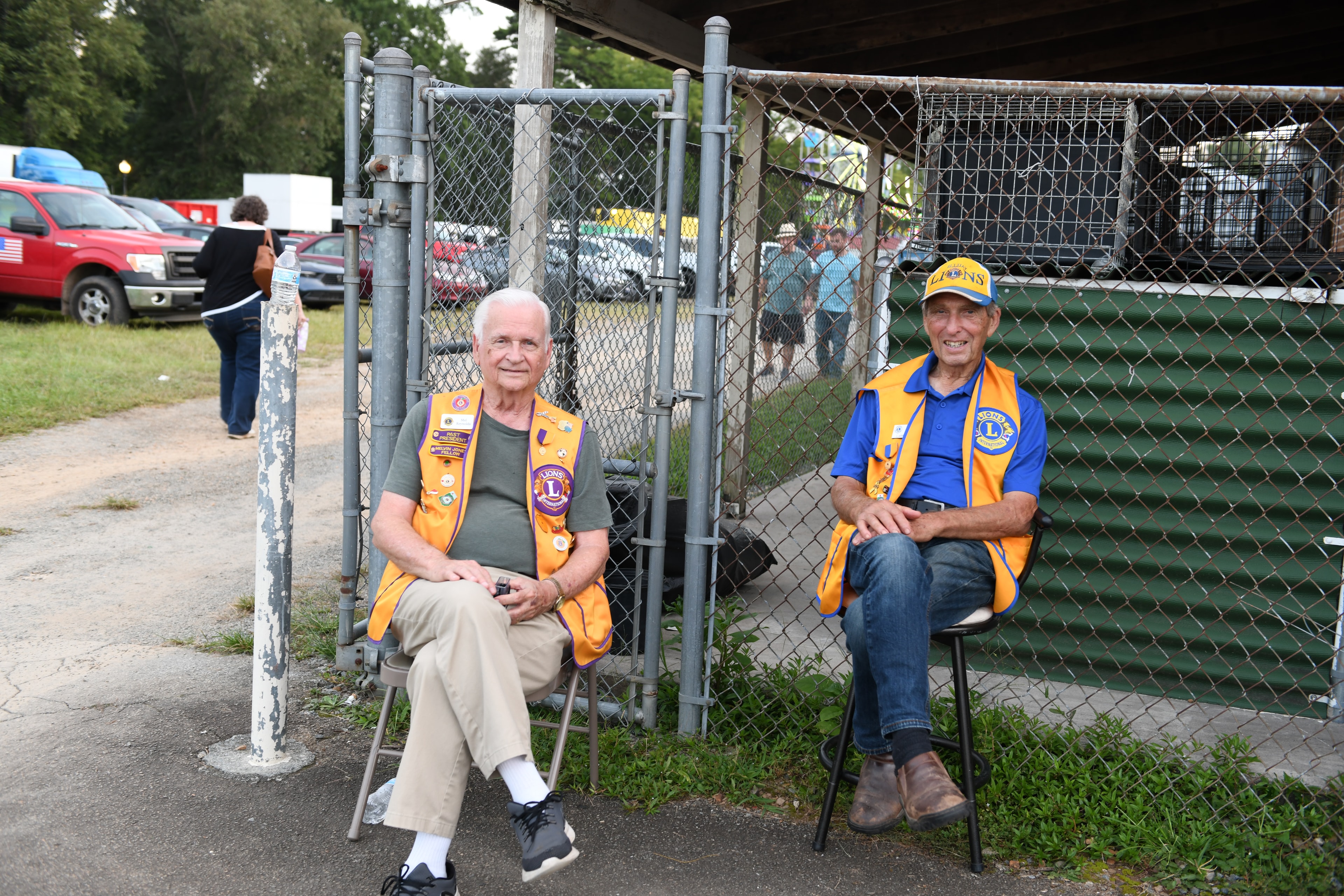 Two Ellijay Lions Club volunteers sitting outdoors at the Fair