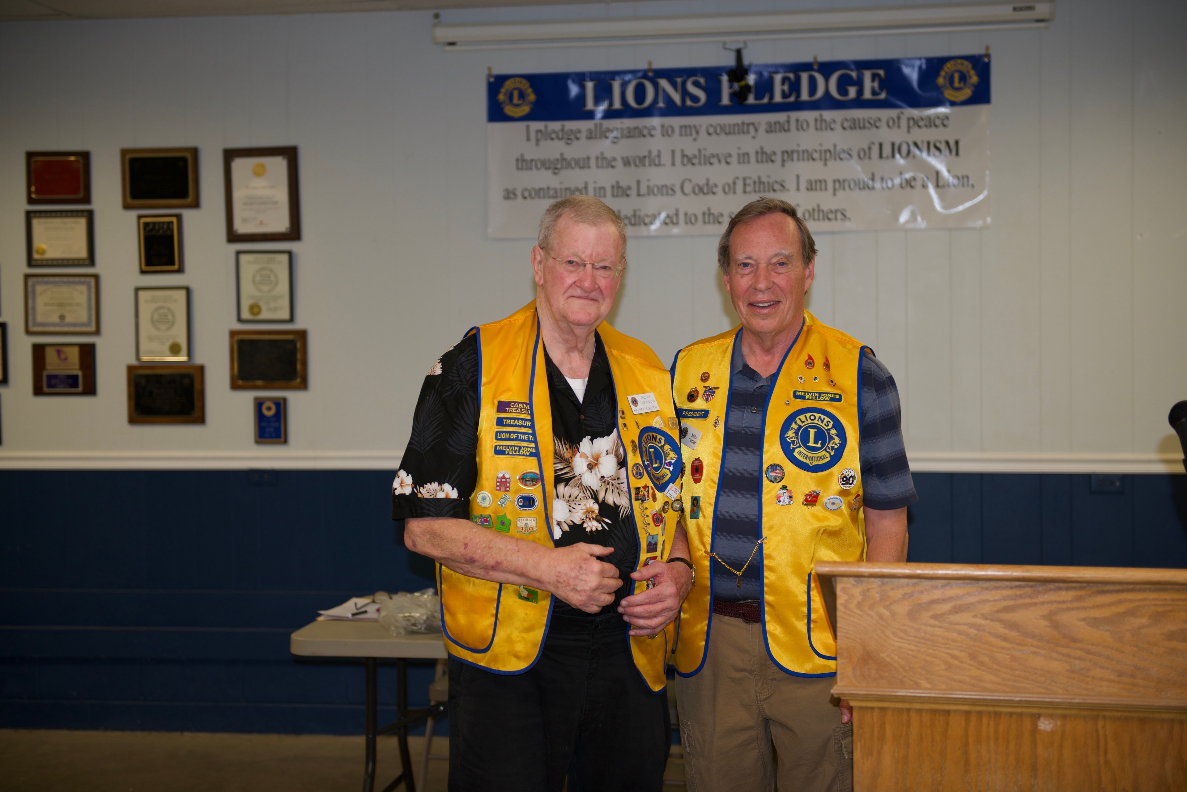 Two Lions Club members wearing yellow vests at the ceremony