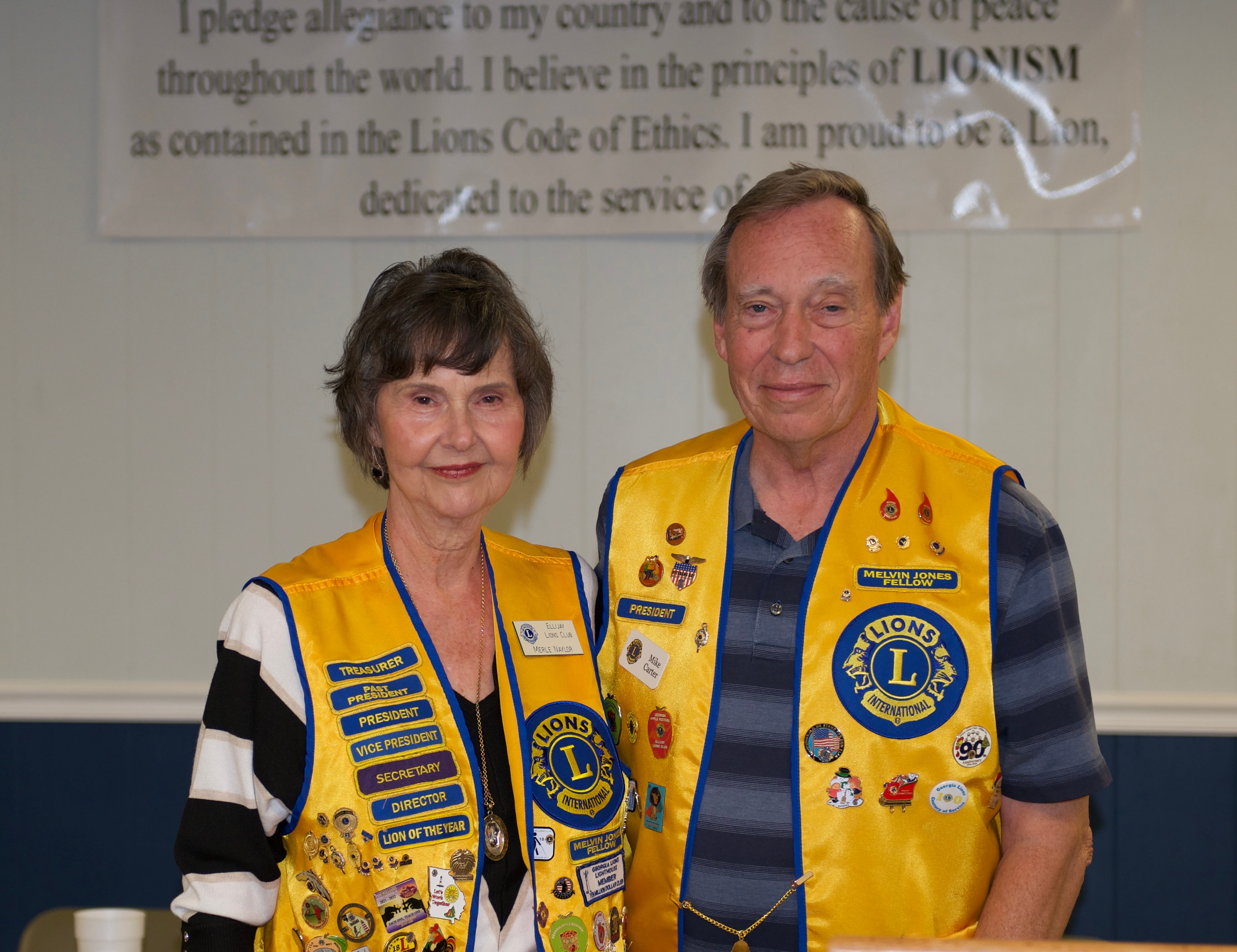 Lions Club members wearing yellow vests at the meeting event